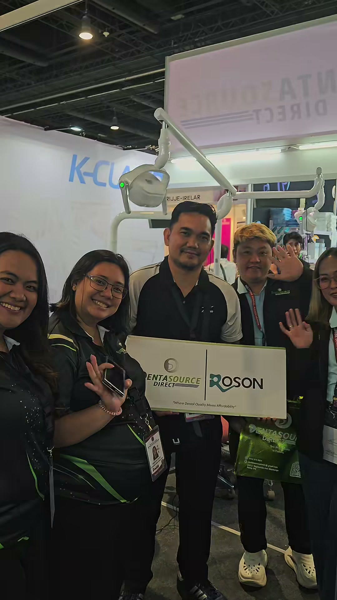 A group of dentists holding the DentaSource and ROSON board