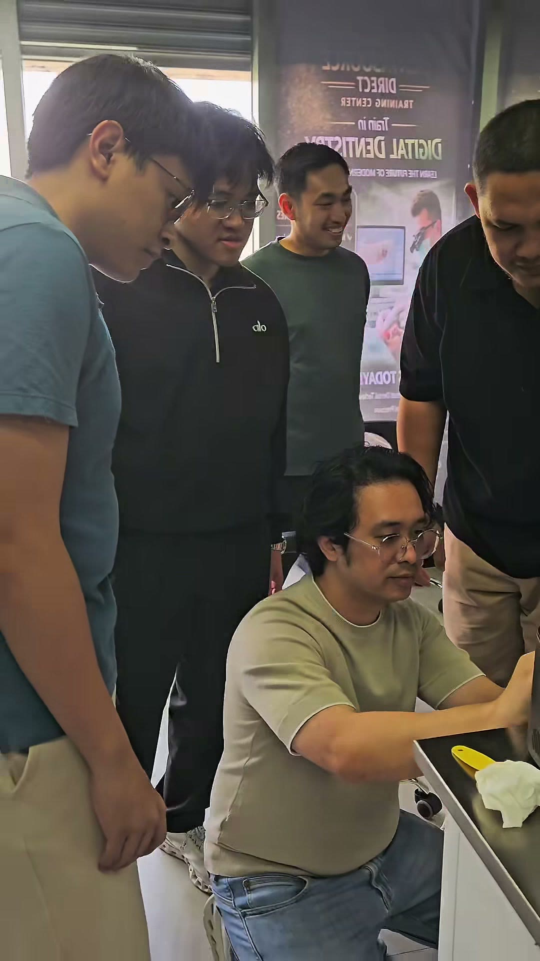 Trainees gathered around the mentor at the bench