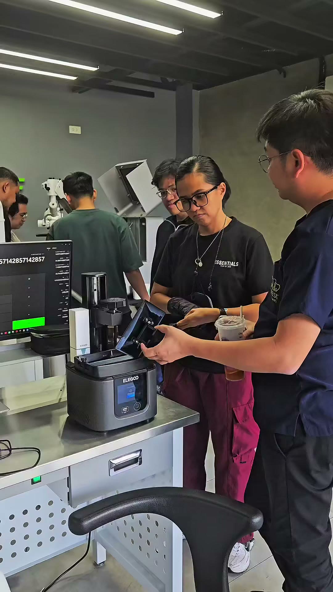 Trainees at the resin printer and the cure unit
