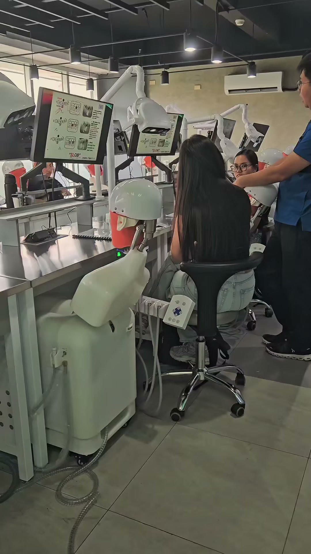 Trainees at the simulator stations with CBCT slices on their screens