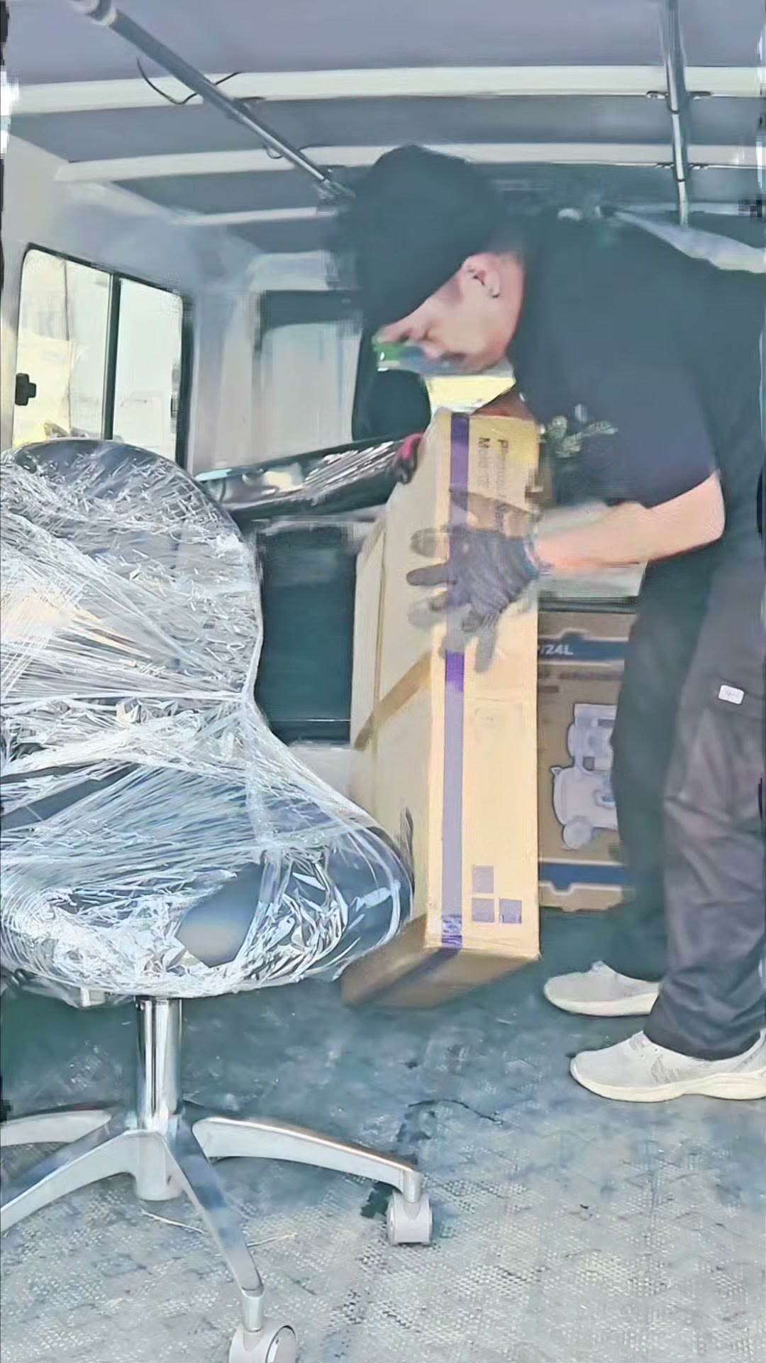 Our technician unloading the ROSON carton beside a wrapped dentist stool