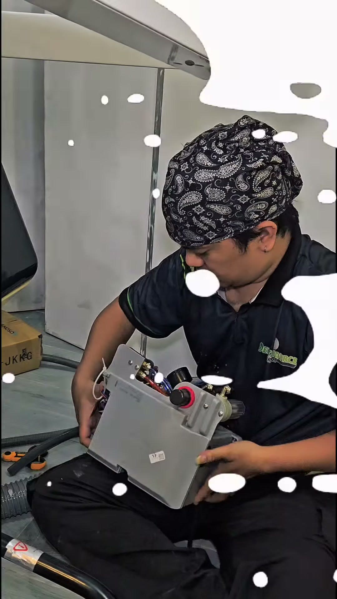 Holding the control box before wiring the services