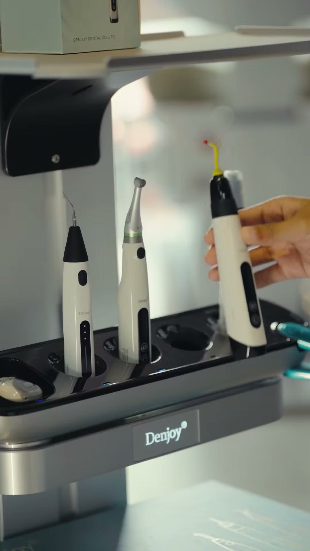 A hand lifting a Denjoy device out of the dock