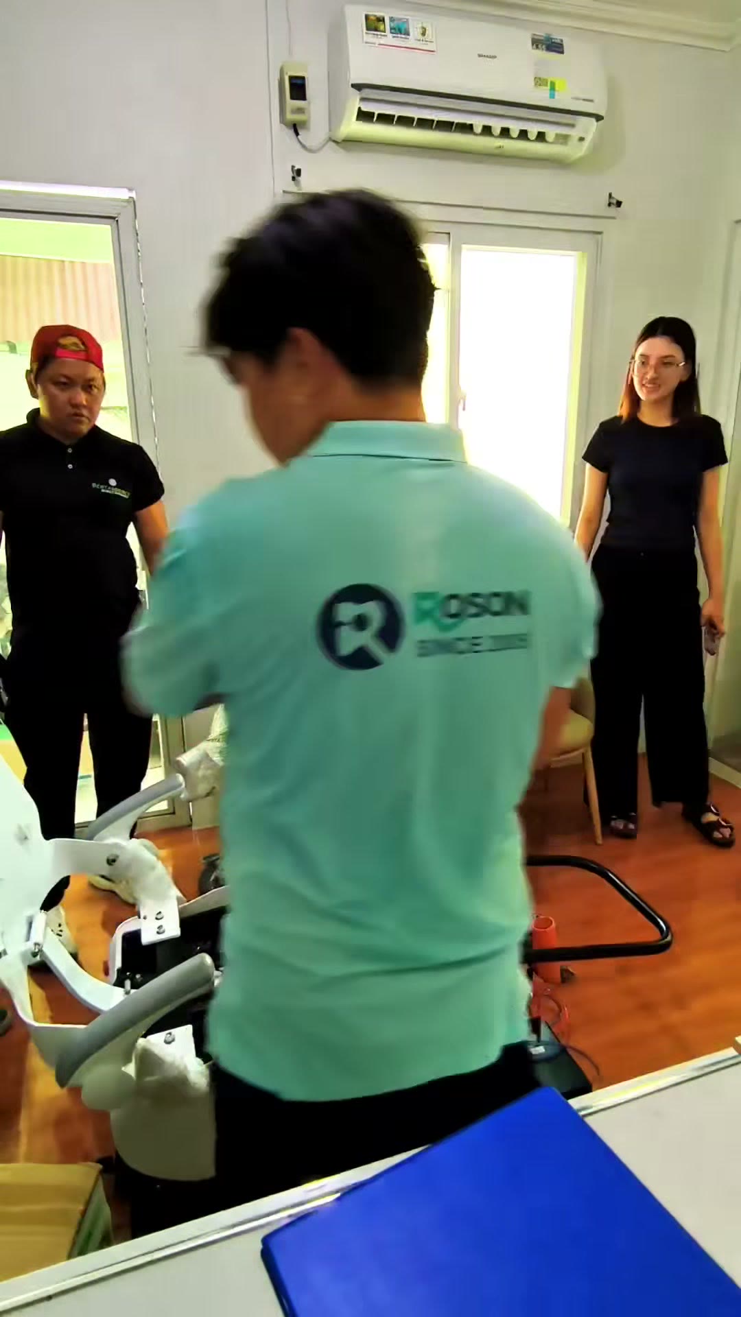 Our technician in a ROSON polo assembling the dental unit on site