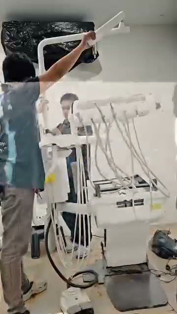 Our technician removing the dental light arm from the unit