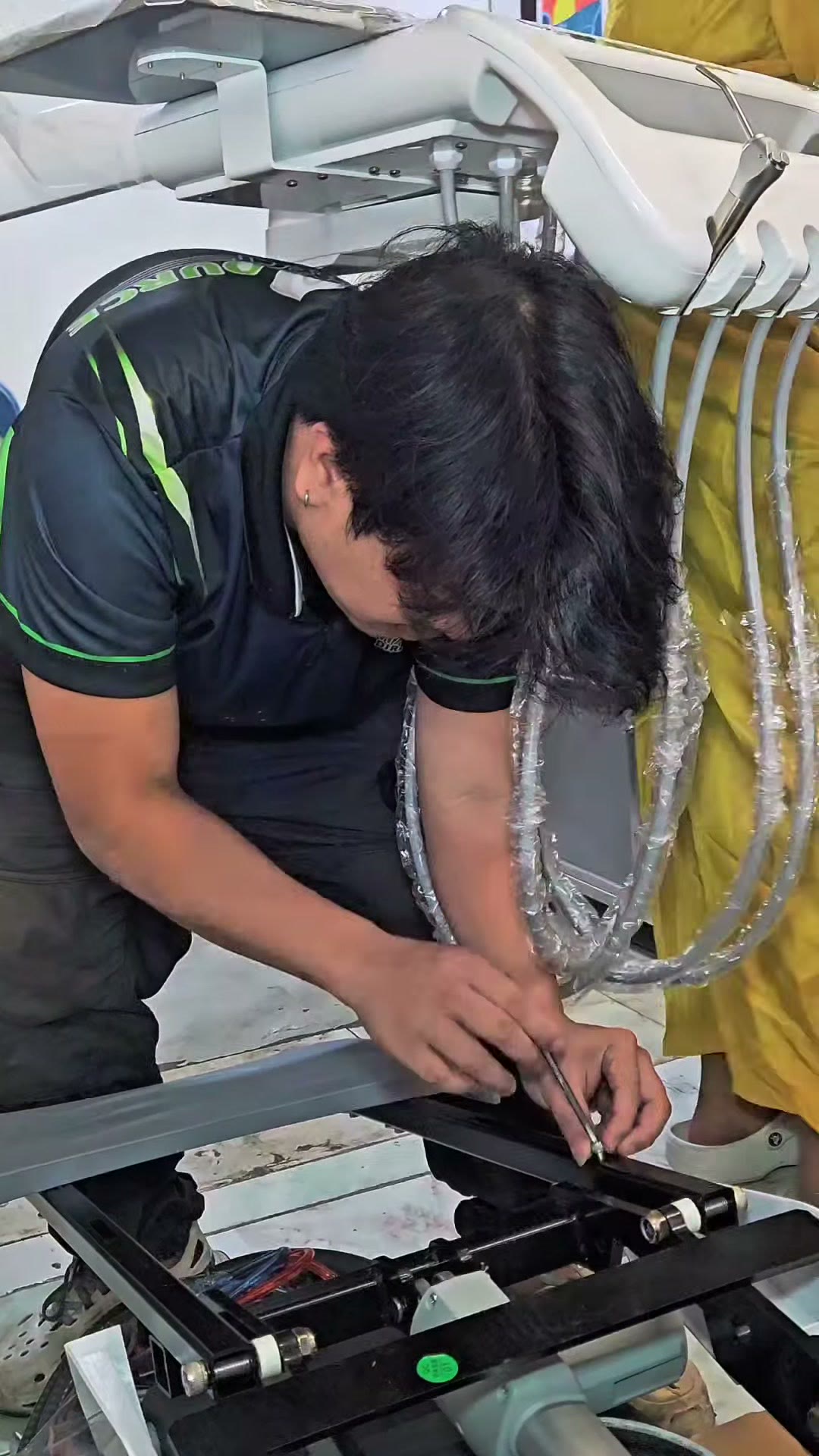 Technician working at the base of the new dental chair