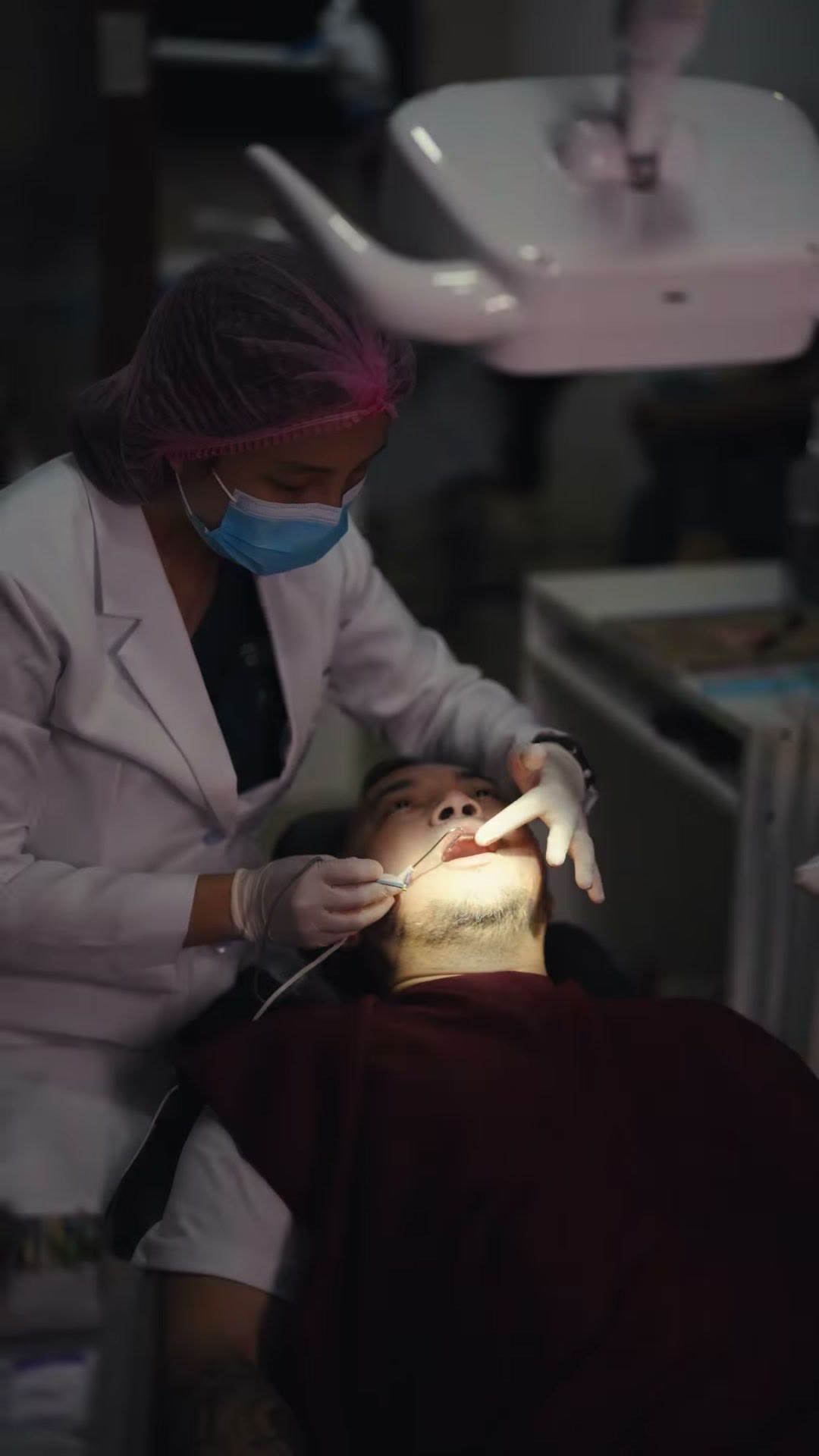 The dentist treating a patient during a root canal appointment