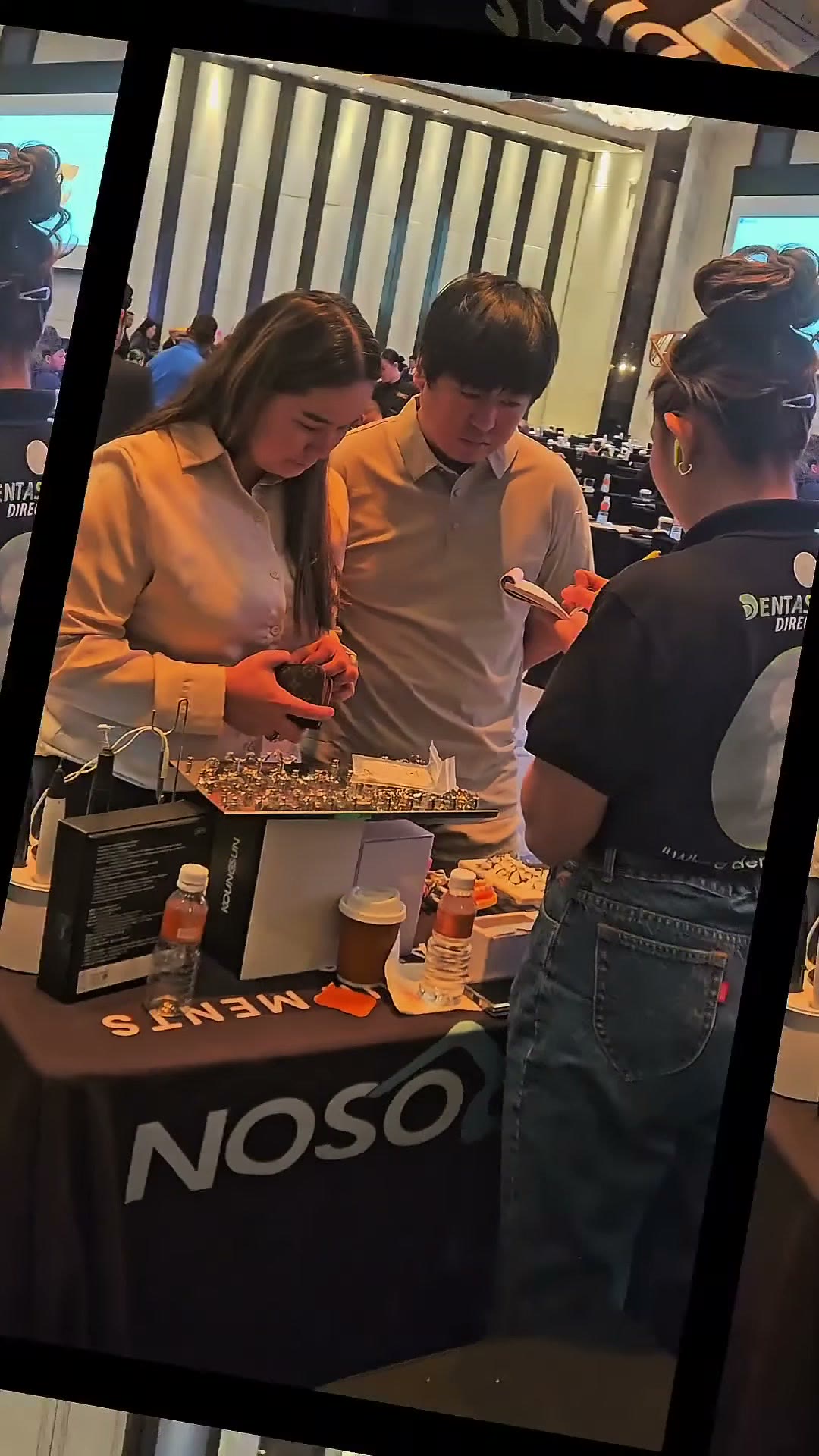 Visitors at the DentaSource table on the final stretch of the convention