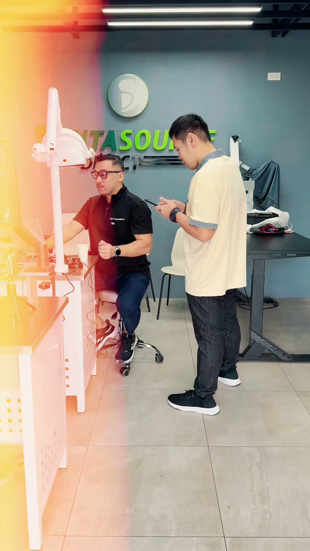 The instructor and a trainee working together at the bench