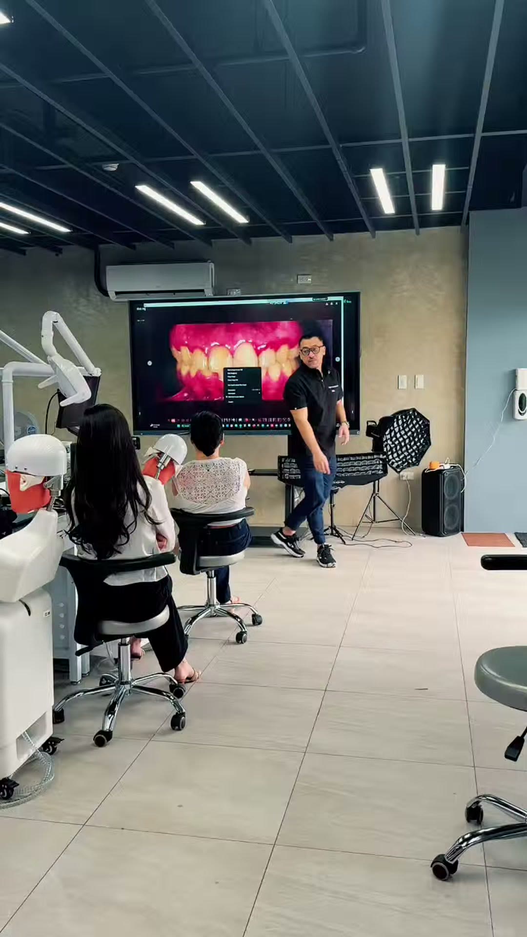 The training room with an intraoral photograph on the large screen and trainees seated