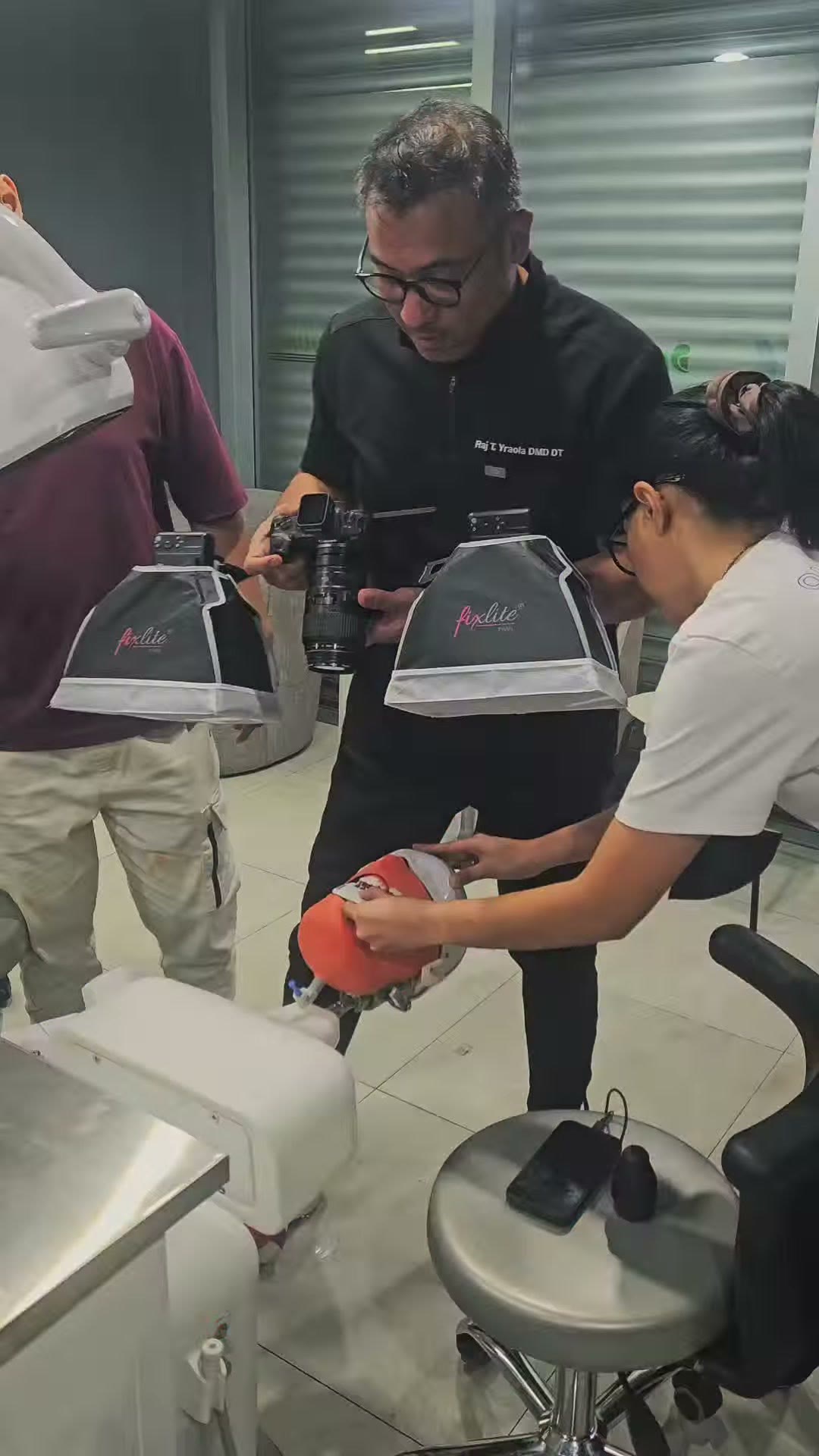 The instructor holding the phantom head with the shade device