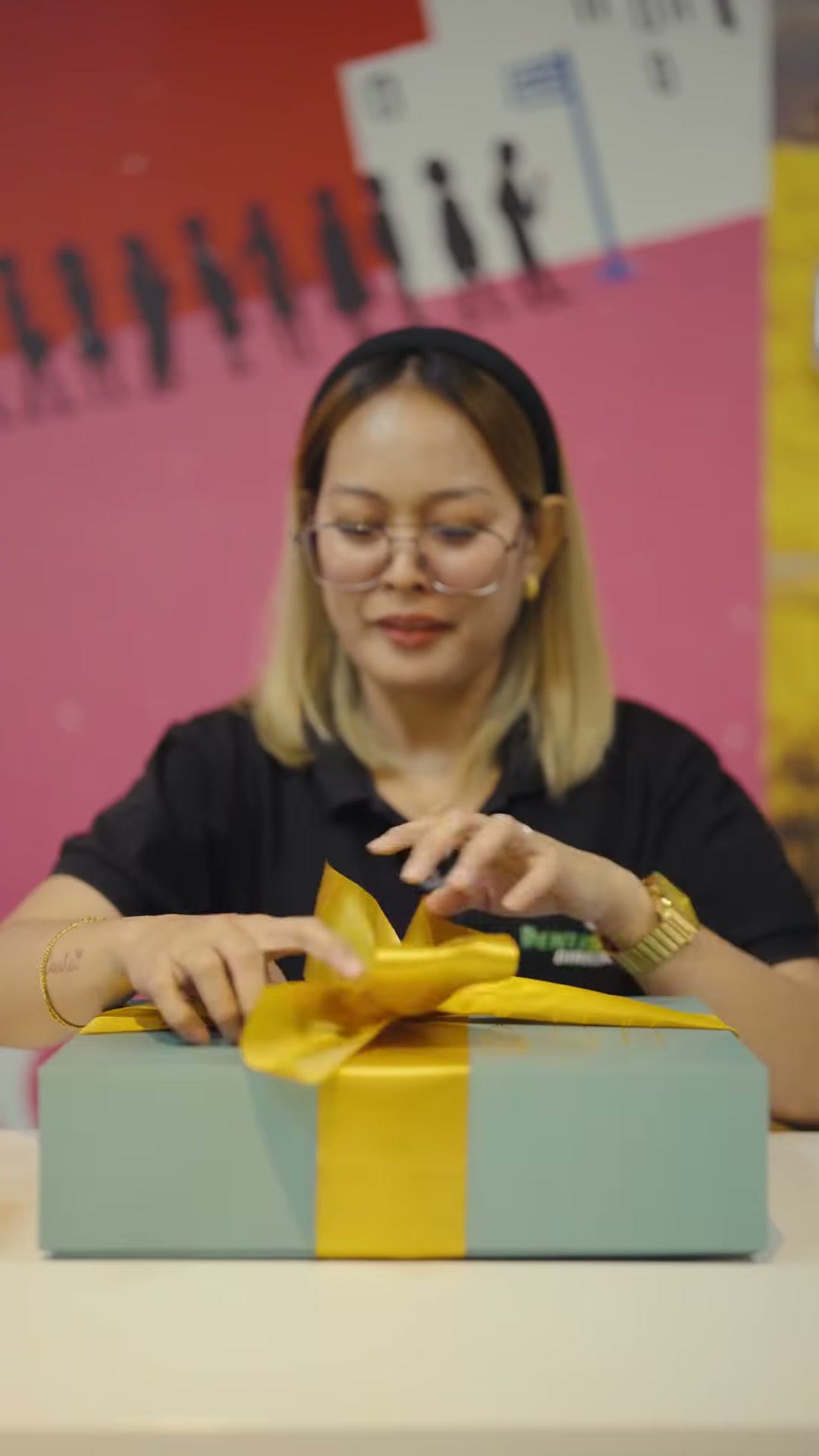 Untying the ribbon on a sealed Denjoy presentation box