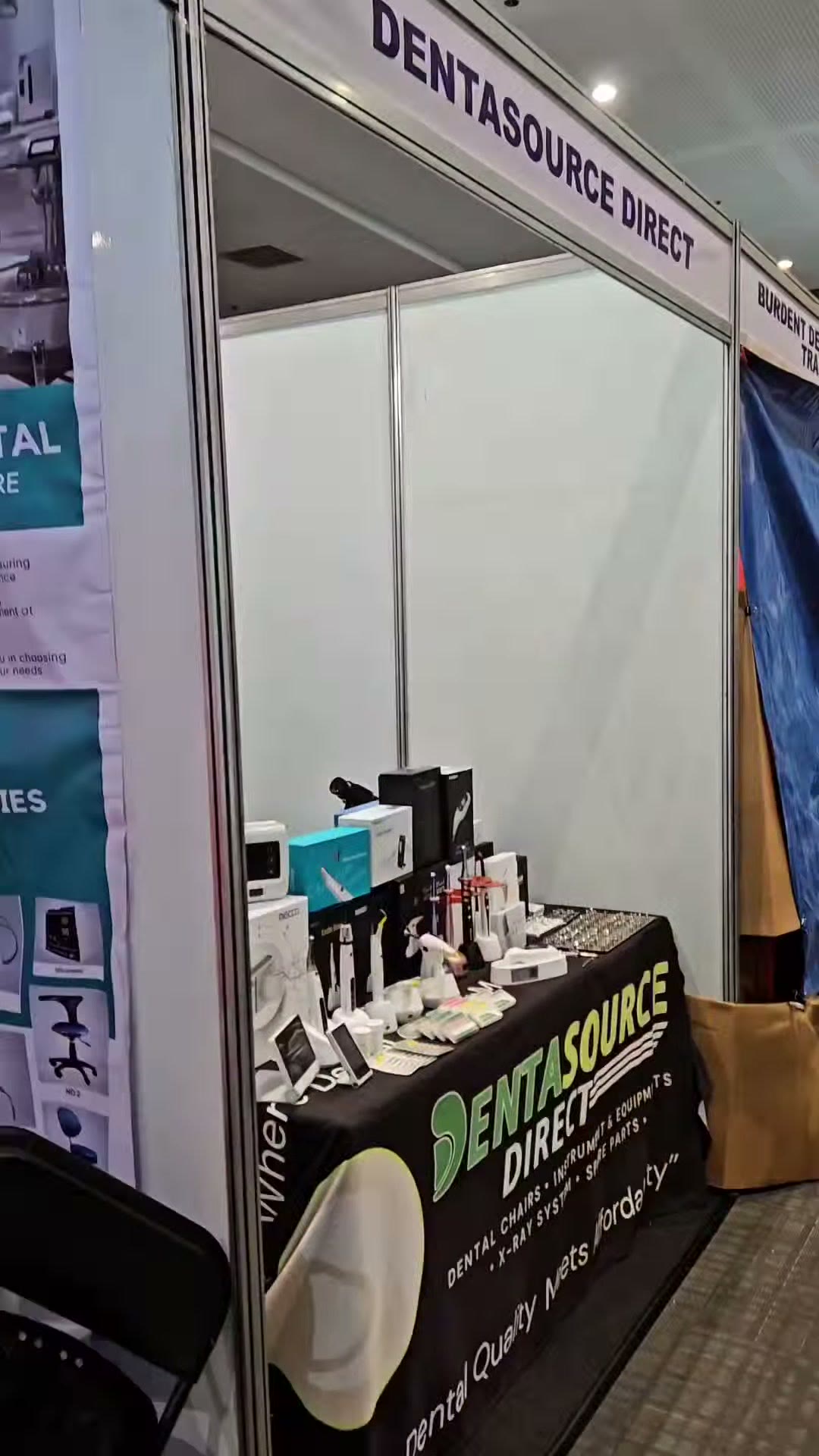 The DentaSource Direct booth with small equipment and roll up banners
