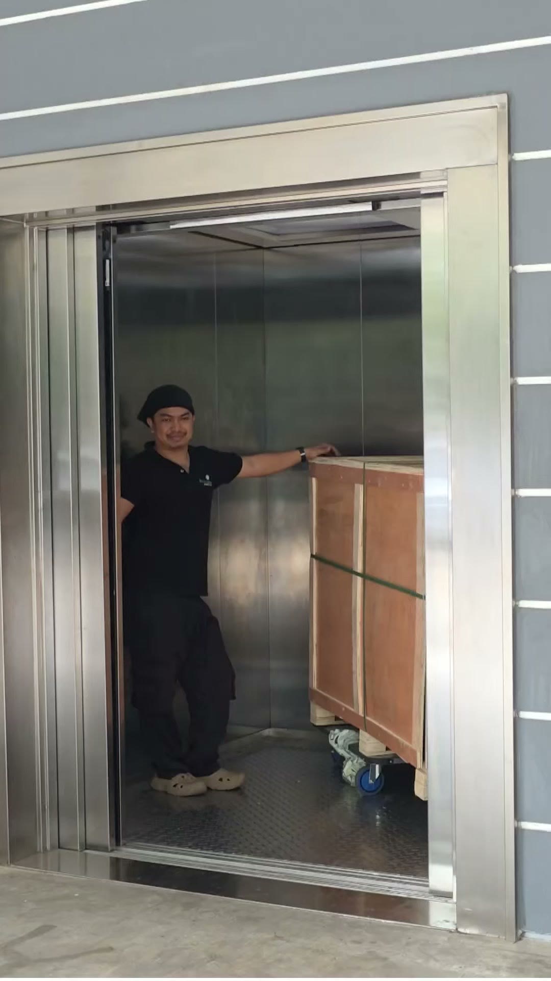 Lifting a crate clear of the truck bed onto the waiting dolly