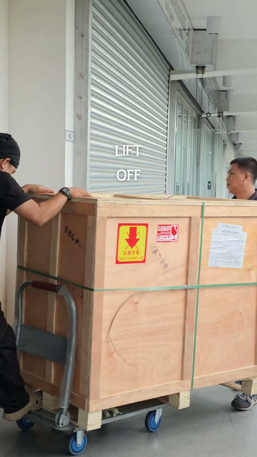A crate rolling out of the truck at the loading dock