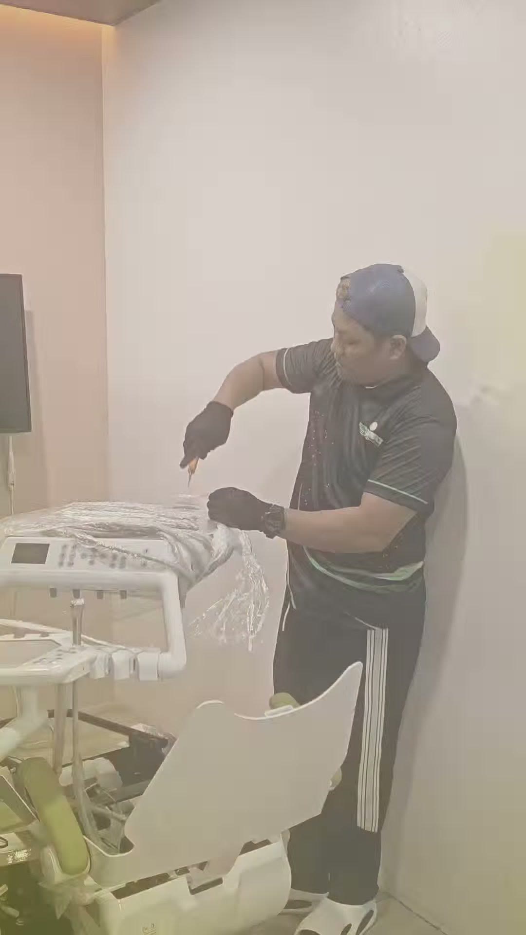 Unpacking the new DX-A3 chair from its wrapping inside the clinic