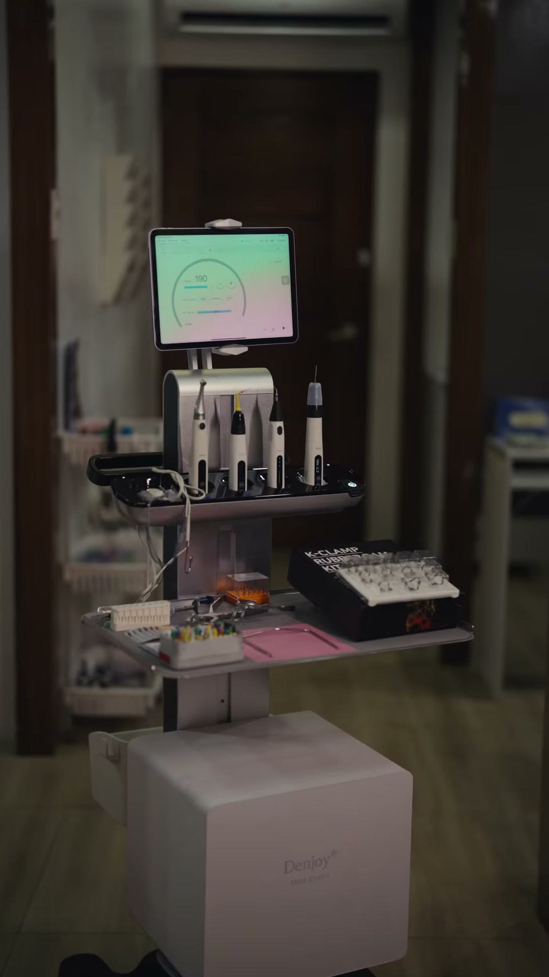 The mobile endodontic cart in the clinic corridor between rooms