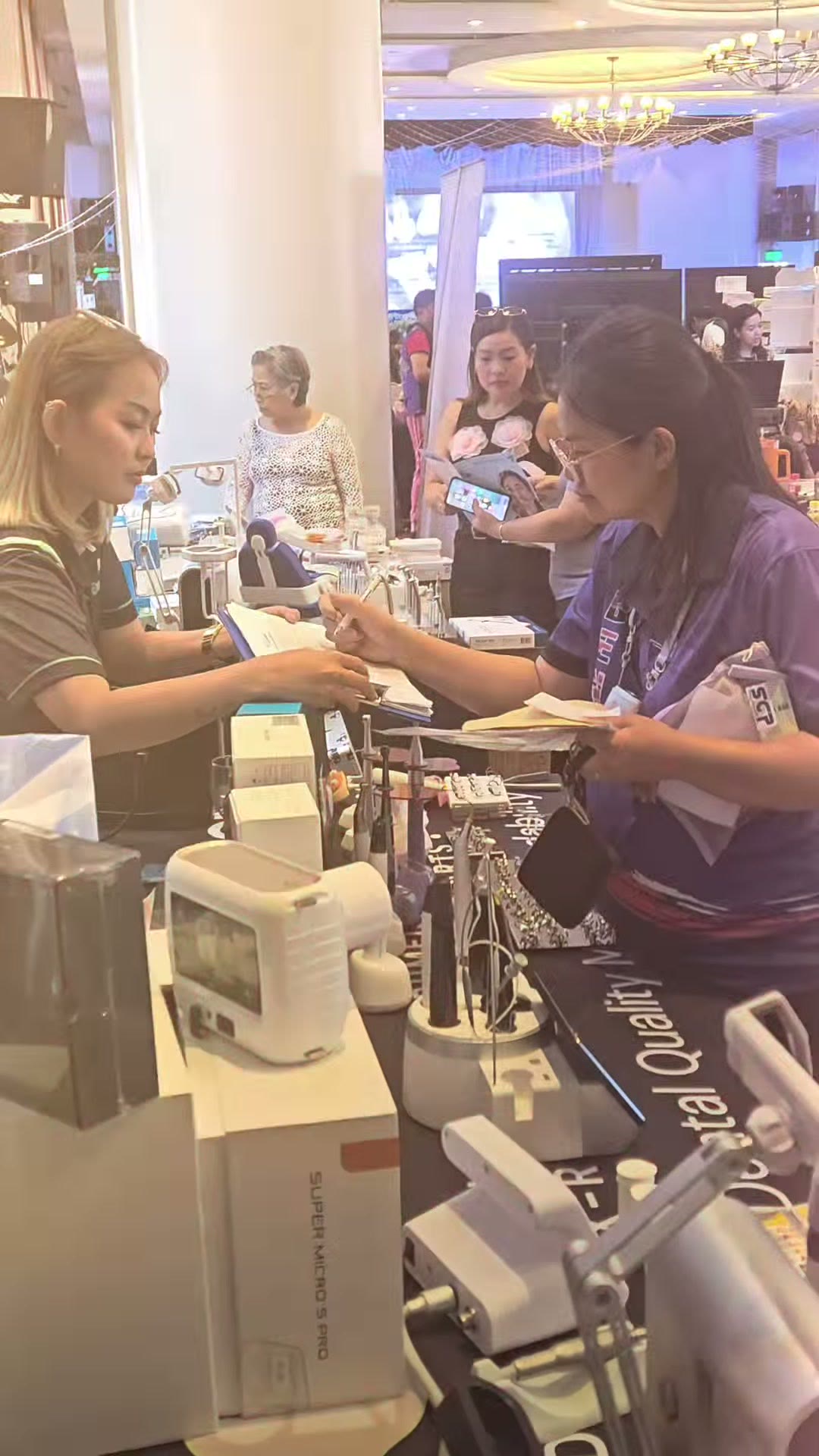 Our staff and a dentist talking at the equipment table