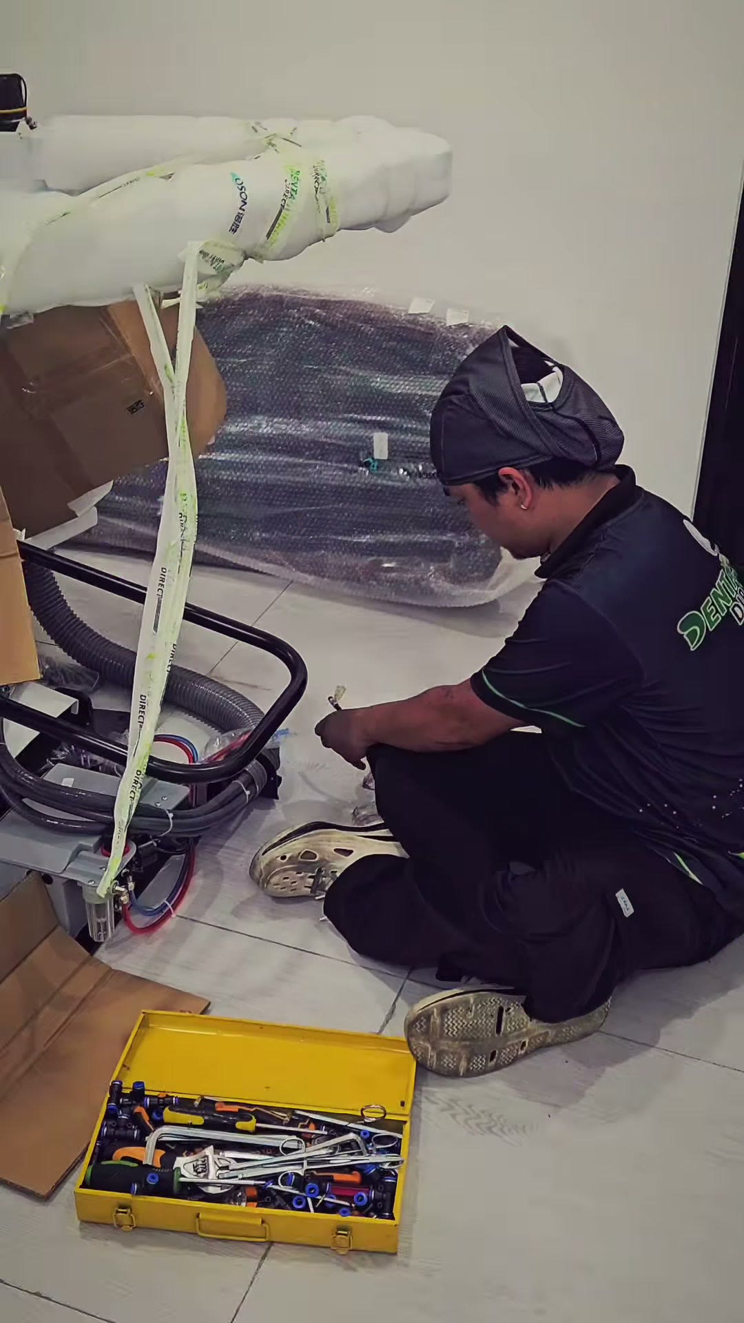 Our technician working on the floor with the chair base