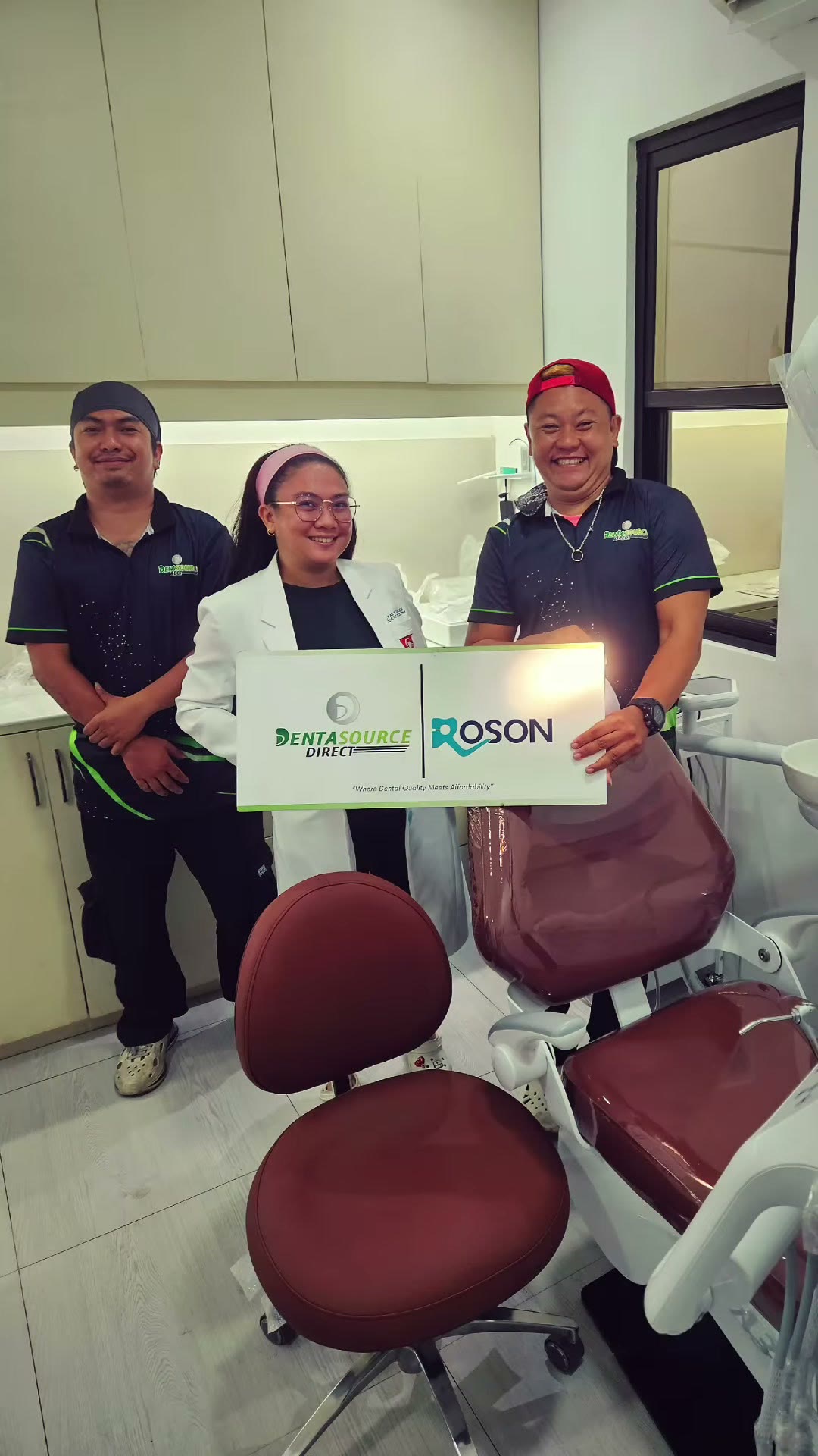 Our team with the dentist beside the burgundy DX-A3 chairs
