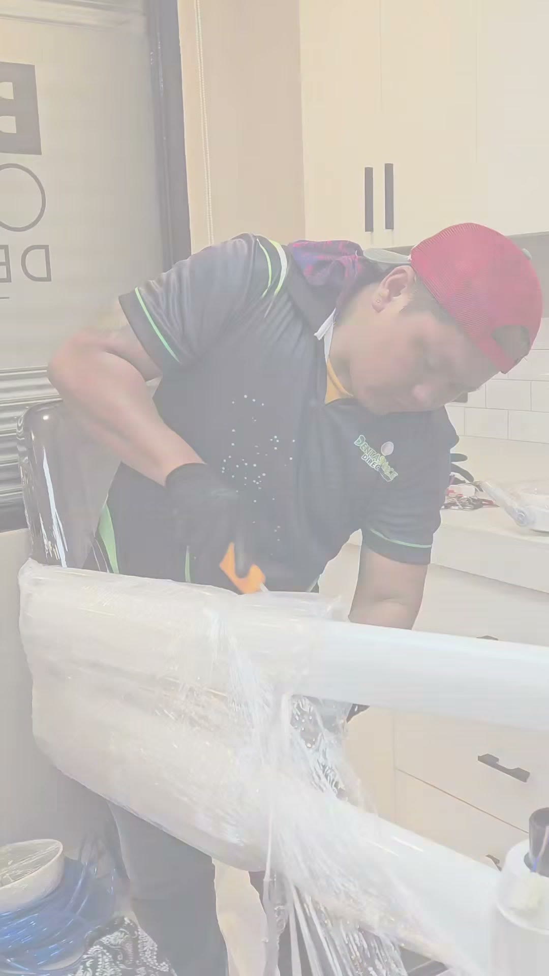 Unwrapping the crated DX-A3S under the clinic signage