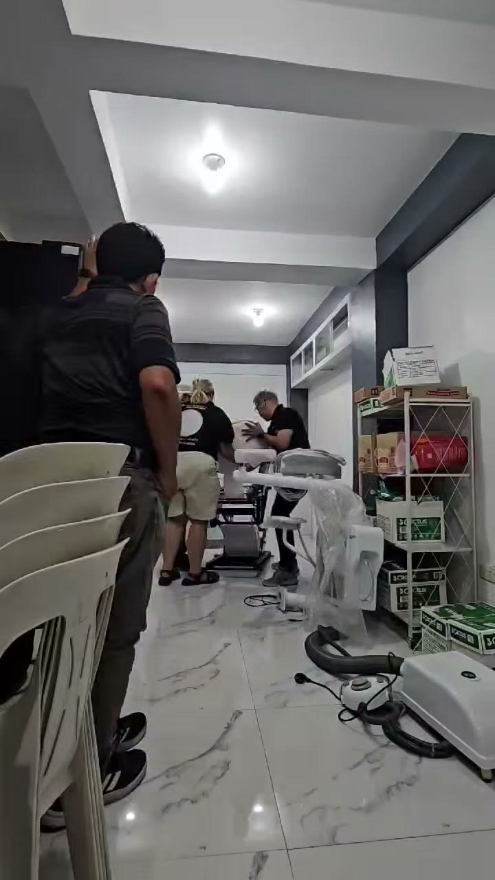 Our technicians assembling the chair beside the supply shelves
