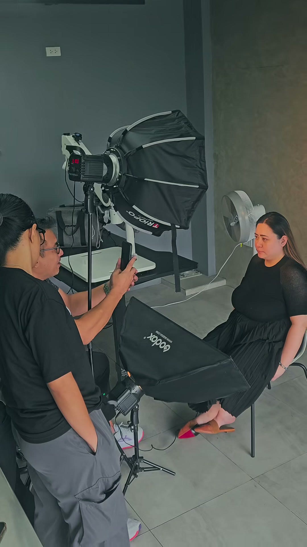 Photographing a volunteer under the softbox studio light