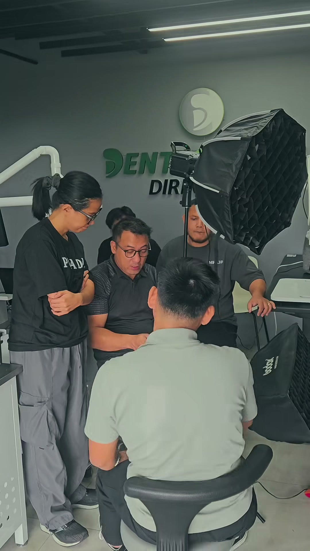 The group at the camera setup under the DentaSource sign