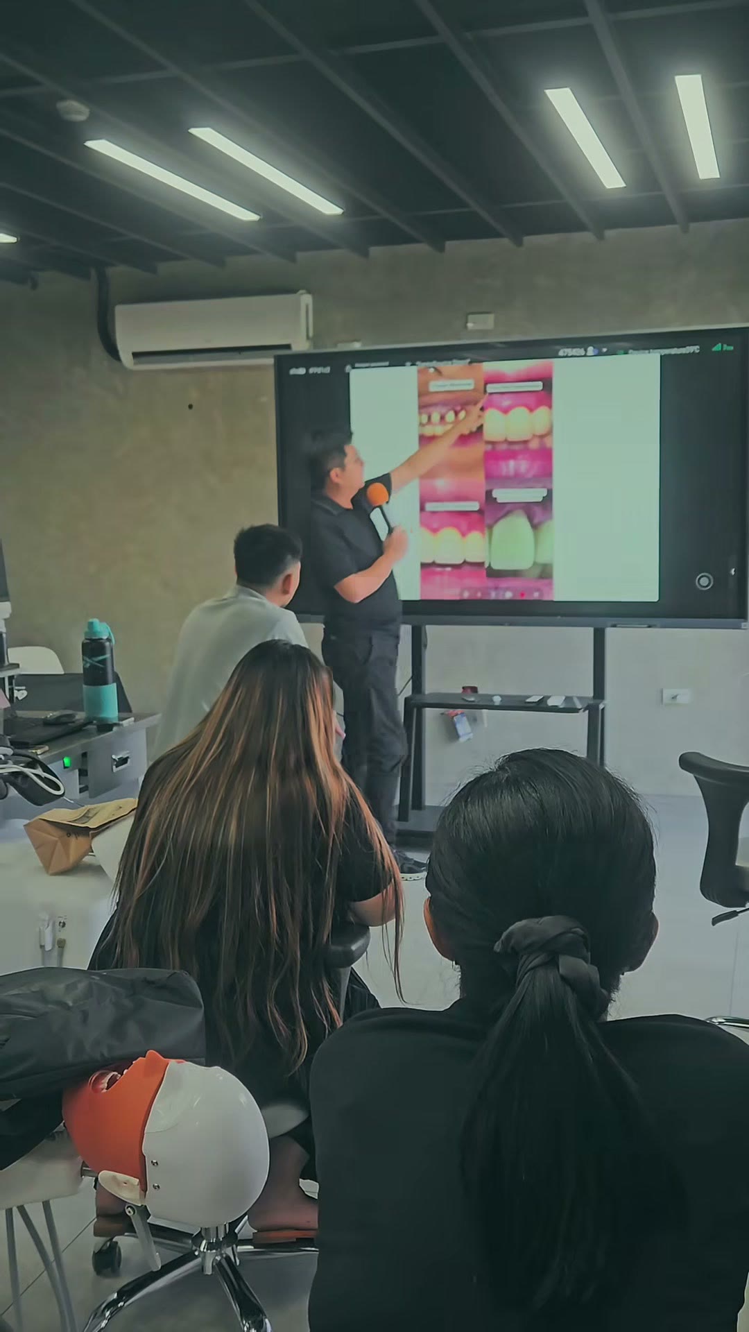 The instructor at a screen of intraoral images