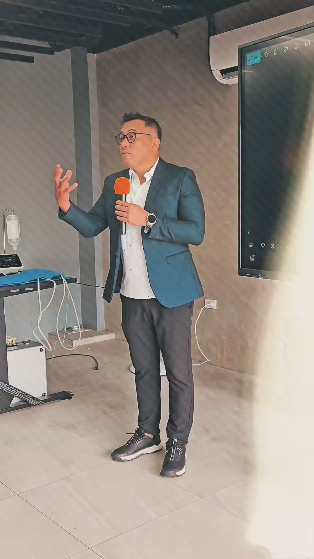 The instructor addressing the room with a microphone