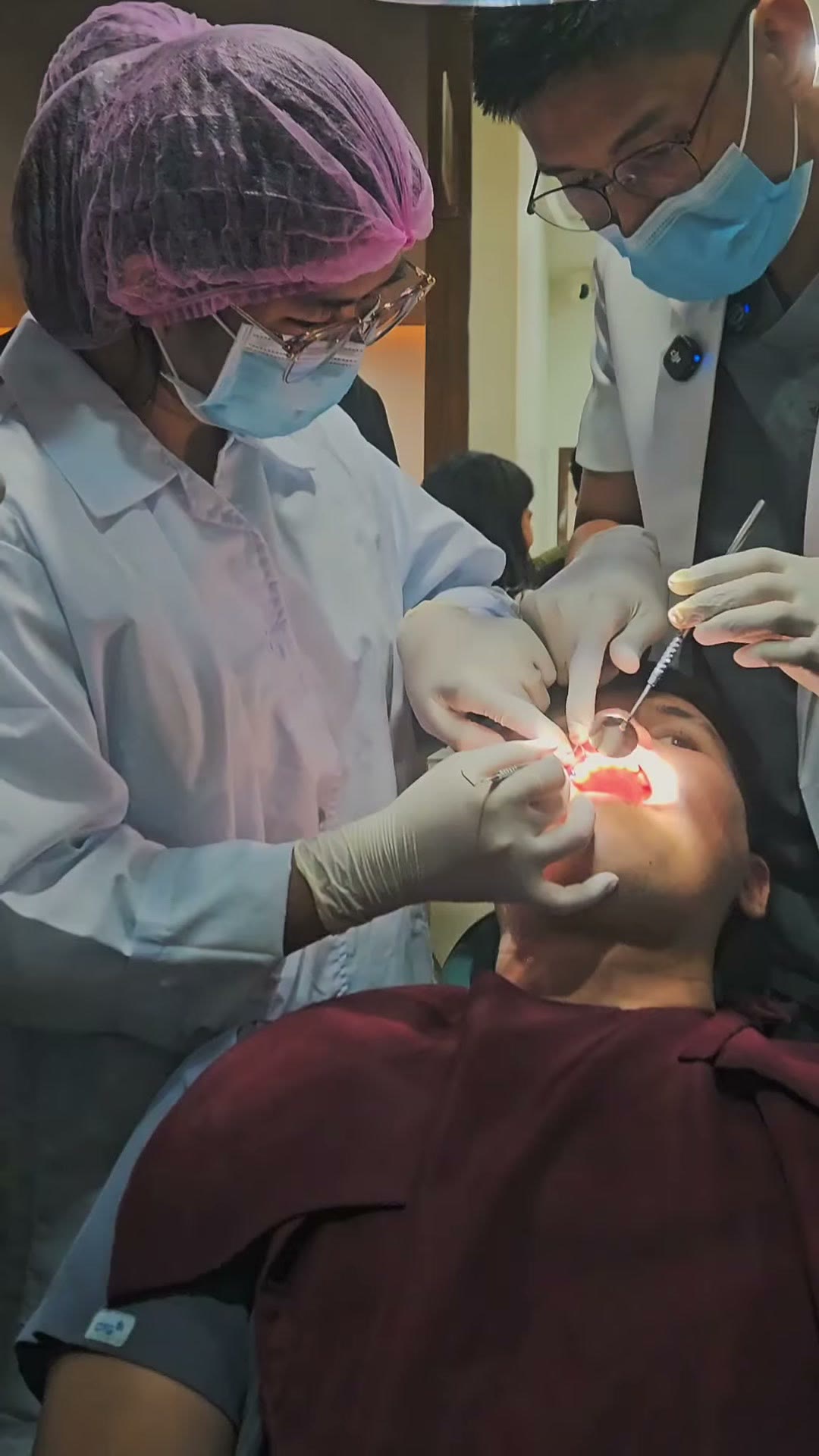 A dentist examining the patient's mouth after placement