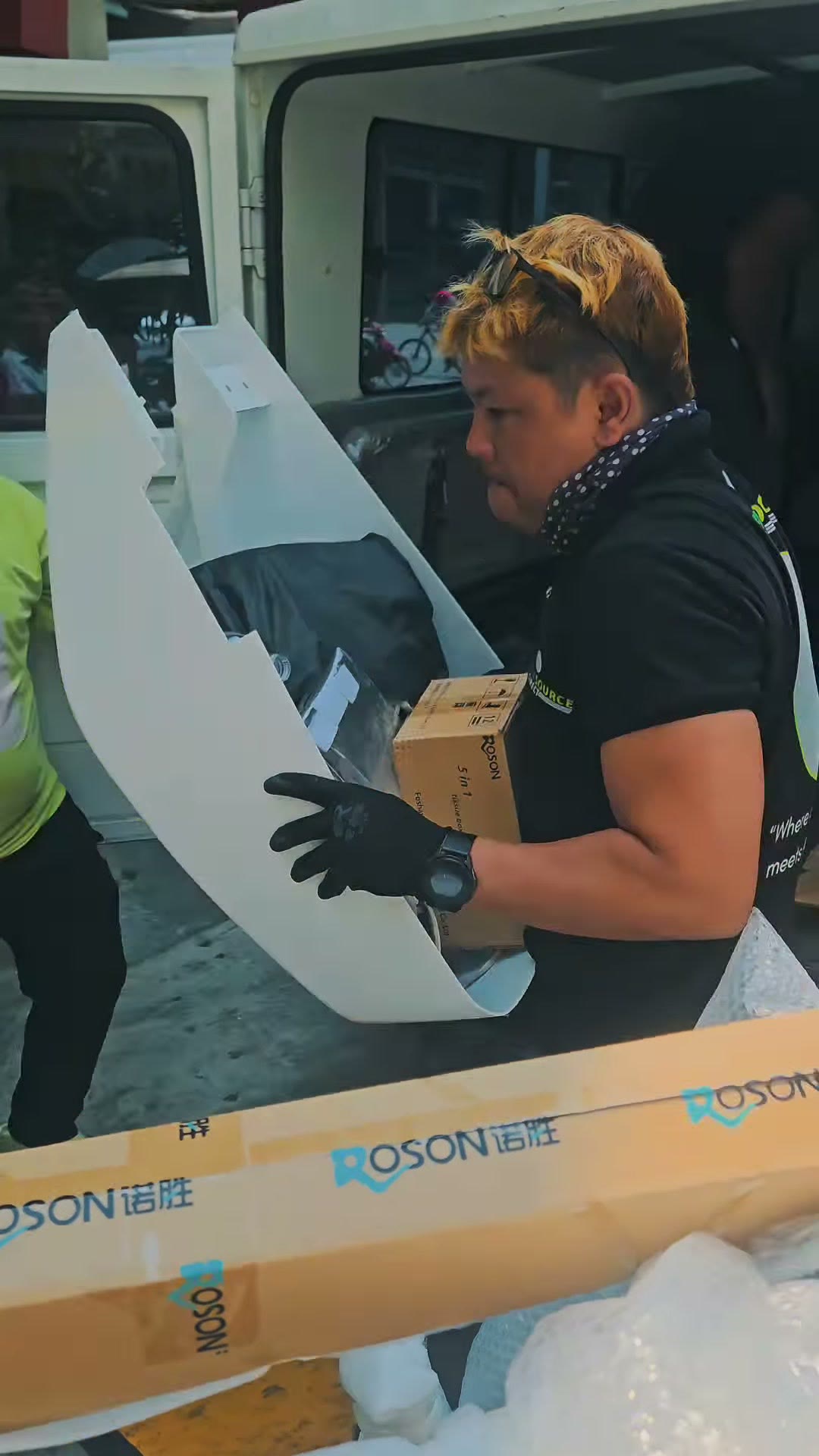 Carrying a panel and a box up to the clinic