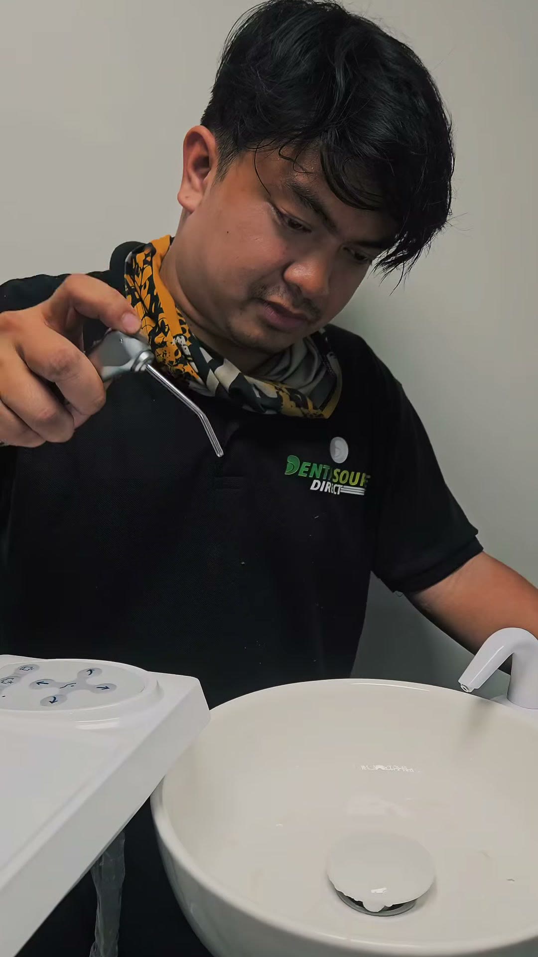 Fitting the faucet to the ceramic spittoon