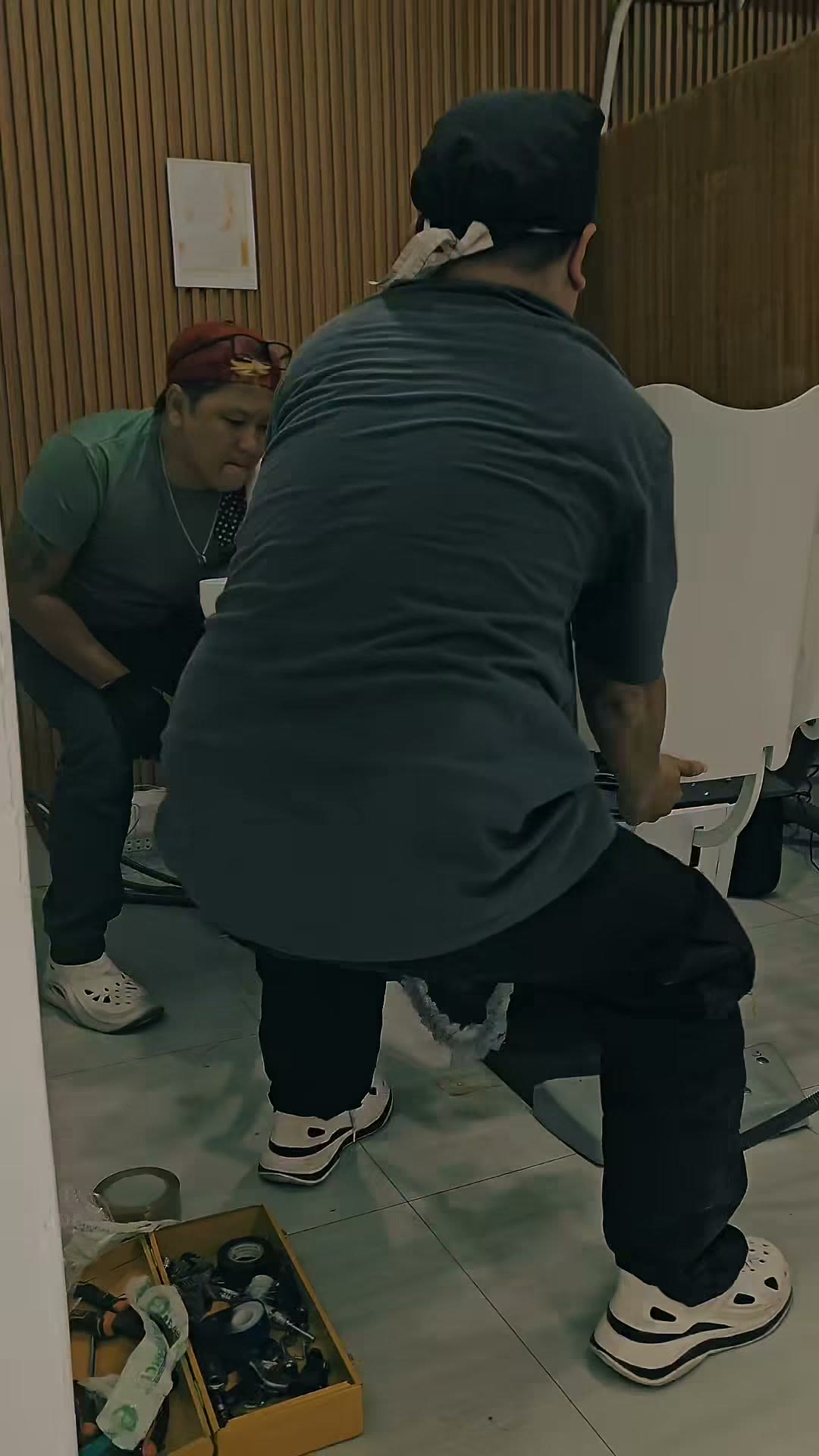 Two technicians checking the chair movement