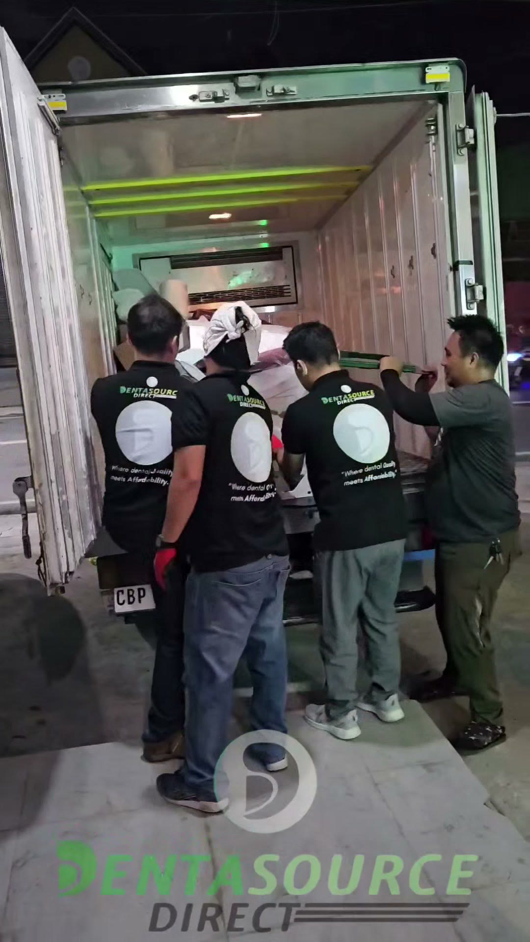 The crew unloading crates from the truck at night