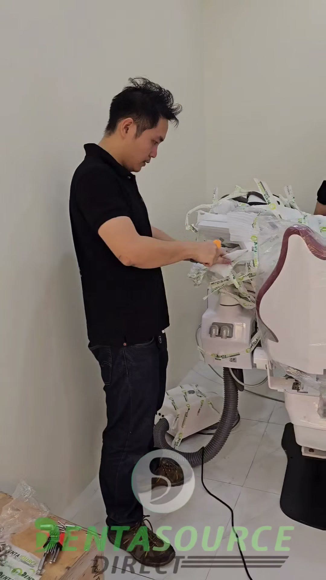 Technician cutting the wrapping off the delivery unit