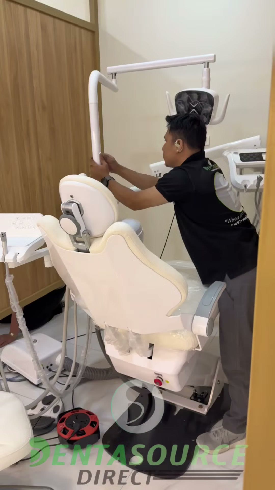 Technician raising the light arm over the assembled chair