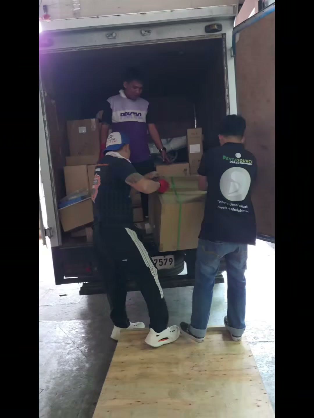 Our team unloading the crated DX-A3 units from the truck at night