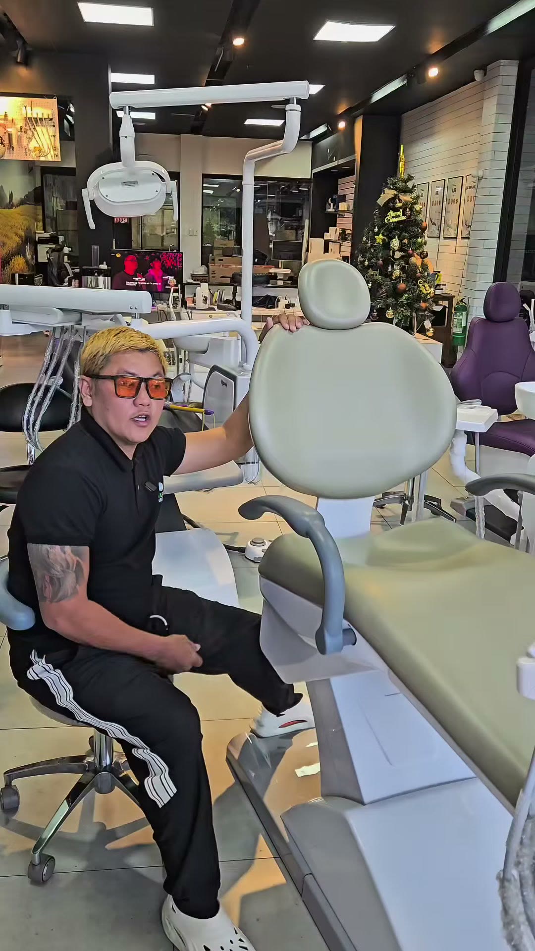 A green upholstered dental chair on display in the showroom